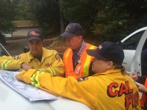 Dr. John Madigan, center, working with CalFire officials.